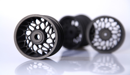 The spindles within the wheels and varying wheel thicknesses would be difficult or nearly impossible to produce conventionally.