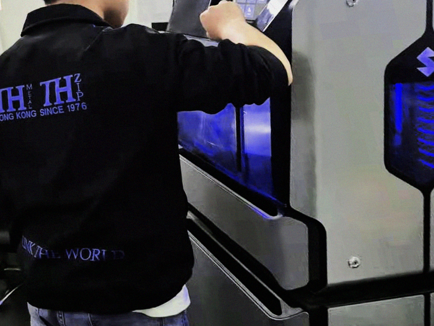 Man at TH Zipper uses the Stratasys J55 to make pullers and buttons prototypes