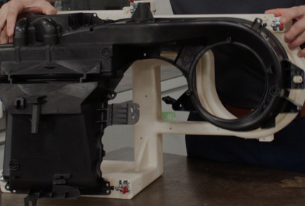 an engineer assembles a 3d printed automotive fixture for mahle
