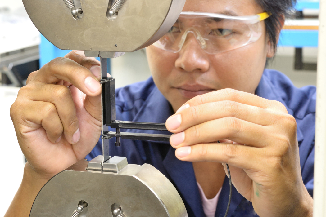 A human inspecting a 3d printed part with great detail. 