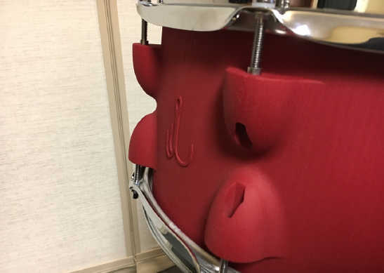 3d printed red snare with hardware attached