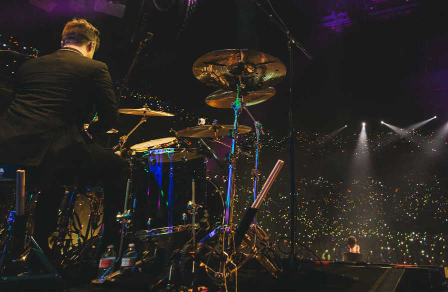 dan pawlovich performs with panic! at the disco in an arena