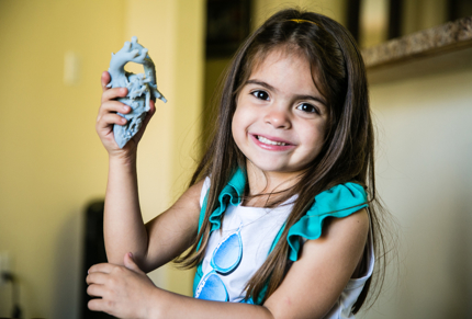 Little girl holding model of her heart