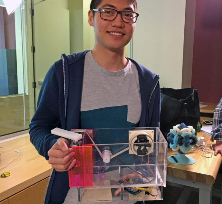 A student proudly shows off their 3d printed tape dispenser.