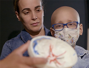 a-woman-and-a-kid-holding-3d-skull-model.