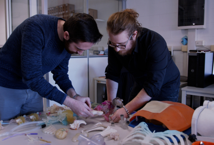 two-men-examining-3d-anatomical-printed-model.