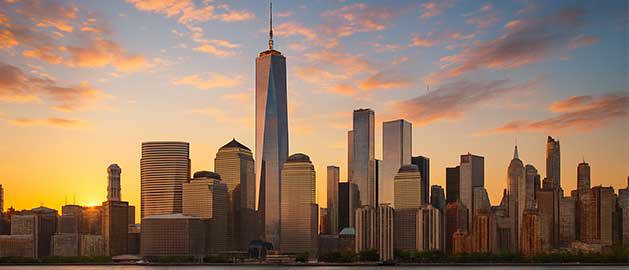 New York City skyline at sunset featuring iconic skyscrapers, representing Stratasys Direct’s advanced 3D printing services for businesses across New York.