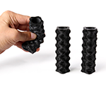 Hand holding 3D printed Stretch 80 cylinder and demonstrating it's flexibility by bending it.