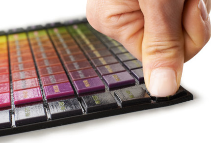 person pressing 3d printed color polyJet part | Stratasys Direct