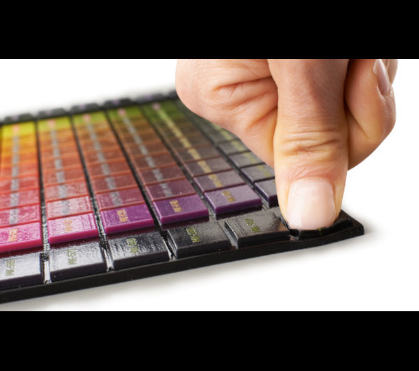 person pressing 3d printed color polyJet part | Stratasys Direct