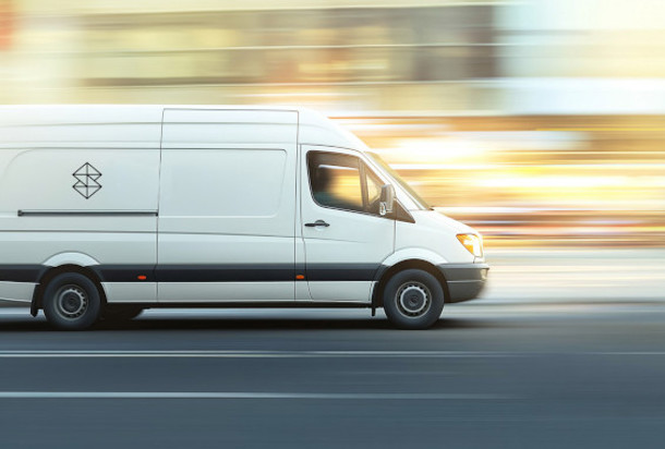 Delivery truck with Stratasys Direct signet on side driving fast