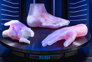 3D printed anatomical models of a human hand, foot, and knee joint with visible internal structures, created by Stratasys Direct for medical prototyping.