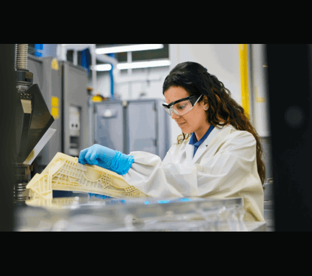 Woman inspecting 3d printed part Stratasys Direct