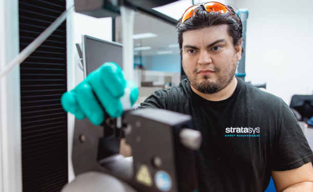 Man pulling FDM Services 3d printed tensile bar Stratasys Direct
