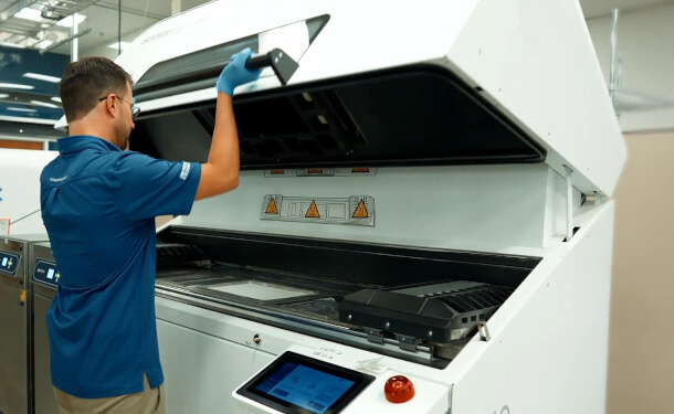 Engineer opening SAF 3D Printer at Stratasys Direct